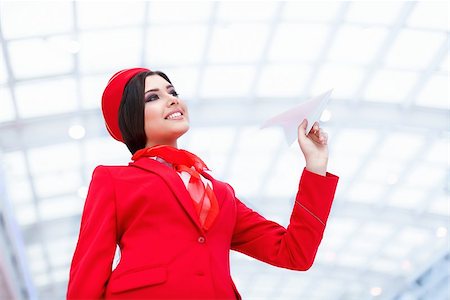 simsearch:400-04429524,k - Young stewardess with a plane Stock Photo - Budget Royalty-Free & Subscription, Code: 400-08790165