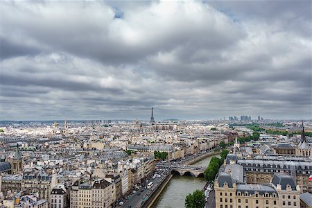 paris rooftops skyline eiffel - Cloudy day and Eiffel tower with la defense over Paris roofs Stock Photo - Budget Royalty-Free & Subscription, Code: 400-08790938