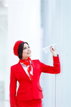simsearch:400-04429524,k - Happy stewardess with a paper airplane Stock Photo - Budget Royalty-Free & Subscription, Code: 400-08792675