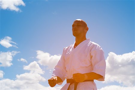 simsearch:400-06860112,k - Man in kimono meditating on sky background Stock Photo - Budget Royalty-Free & Subscription, Code: 400-08793086