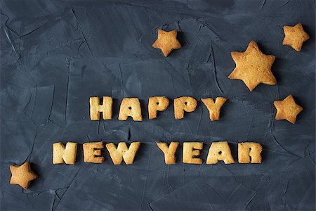 background with baked gingerbread stars and words happy new year on the concrete background. creative idea Stock Photo - Budget Royalty-Free & Subscription, Code: 400-08793201