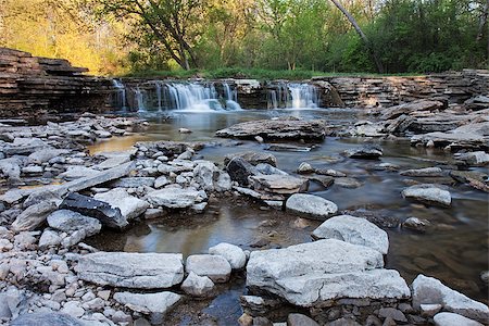 simsearch:400-08793800,k - A waterfall supplies a rocky stream with an ample flow of springtime water. Along the stream, pools of water are formed reflecting the soft colors of the morning sunlit trees. Stock Photo - Budget Royalty-Free & Subscription, Code: 400-08793261