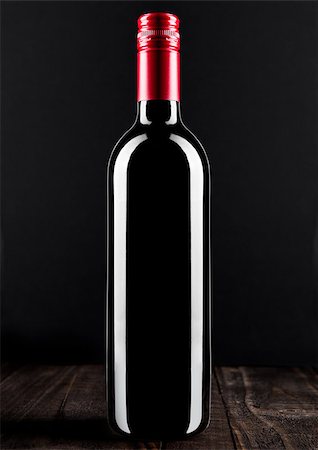 simsearch:400-08793273,k - Bottle of red wine dark glass on wooden bacground red top Foto de stock - Super Valor sin royalties y Suscripción, Código: 400-08793272