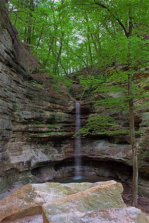 simsearch:400-08793800,k - Glowing like a laser beam, the St. Louis Canyon waterfall in Starved Rock State Park,tumbles to the ground. Limestone rocks and trees stand guard over the waterfall. Stock Photo - Budget Royalty-Free & Subscription, Code: 400-08793800