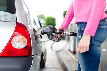 Closeup of woman pumping gasoline fuel in car at gas station. Petrol or gasoline being pumped into a motor vehicle car. Stock Photo - Budget Royalty-Free & Subscription, Code: 400-08806292