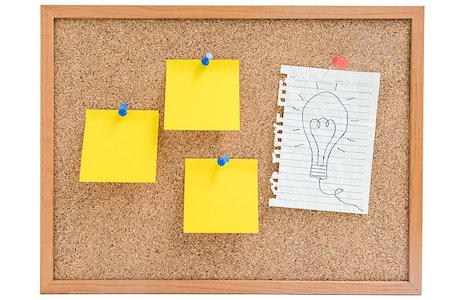 Isolated hand writing idea sign (light bulb) on white paper with yellow sticky notes pin on the wooden board Stock Photo - Budget Royalty-Free & Subscription, Code: 400-08807067