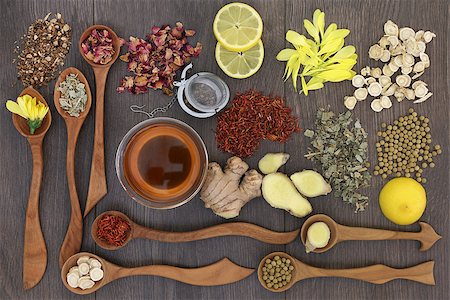 Healthy herbal teas in wooden spoons with glass tea cup and strainer, teas also used in traditional chinese alternative medicine and on oak background. Stock Photo - Budget Royalty-Free & Subscription, Code: 400-08808642