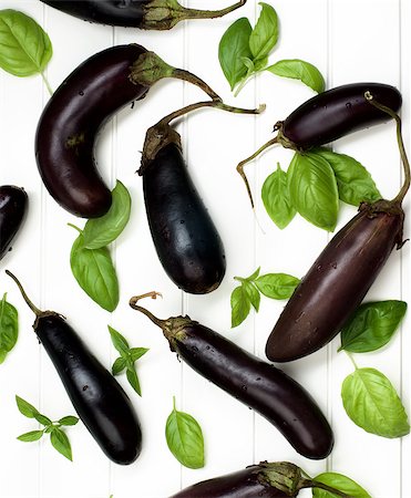 simsearch:400-06857433,k - Arrangement of Fresh Raw Small Eggplants and Green Basil Leafs with Water Drops closeup on White Wooden Plank background. Top View Foto de stock - Super Valor sin royalties y Suscripción, Código: 400-08808983