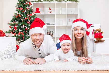 simsearch:400-09222788,k - Happy young family celebrating Christmas at home Photographie de stock - Aubaine LD & Abonnement, Code: 400-08809009