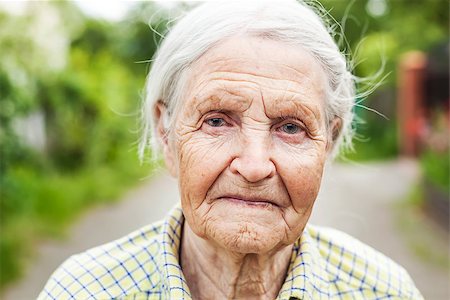 Portrait of an aged woman smiling outdoors Stock Photo - Budget Royalty-Free & Subscription, Code: 400-08809022
