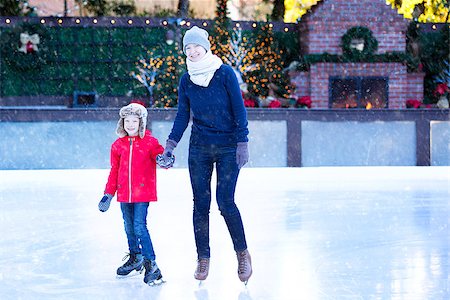 family of two enjoying ice skating at winter at outdoor skating rink decorated for holiday time at snowy weather, winter and family concept Stock Photo - Budget Royalty-Free & Subscription, Code: 400-08809030