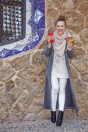 epiphany cake - Winter wonderland in Barcelona at Christmas. Full length portrait of smiling elegant tourist woman with a cup of hot beverage and a piece of traditional king cake at Guell Park in Barcelona, Spain Stock Photo - Budget Royalty-Free & Subscription, Code: 400-08809157