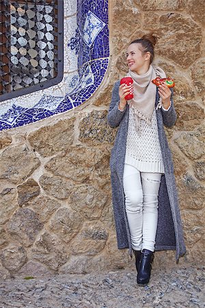 epiphany cake - Winter wonderland in Barcelona at Christmas. Full length portrait of happy young traveller woman with a cup of hot beverage and a piece of traditional king cake at Guell Park in Barcelona, Spain looking aside Stock Photo - Budget Royalty-Free & Subscription, Code: 400-08809159