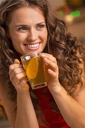 pic of drinking celebration for new year - Happy young woman drinking ginger tea with lemon Stock Photo - Budget Royalty-Free & Subscription, Code: 400-08809167
