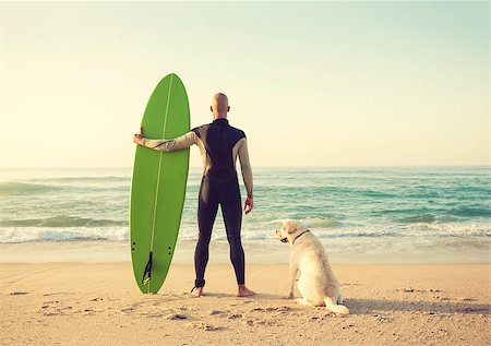 dog and surfing - Surfist on the beach with his best friend Stock Photo - Budget Royalty-Free & Subscription, Code: 400-08809445