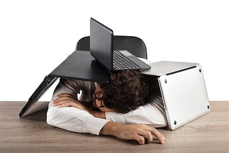 Tired businessman sleeping under a pile of computers Stock Photo - Budget Royalty-Free & Subscription, Code: 400-08809608
