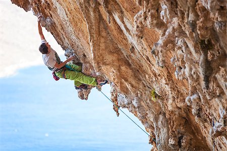 simsearch:400-07292725,k - Male rock climber on a face of a cliff Photographie de stock - Aubaine LD & Abonnement, Code: 400-08814278