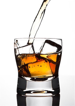 Pouring whiskey to the glass with ice cubes on white background Stock Photo - Budget Royalty-Free & Subscription, Code: 400-08815453