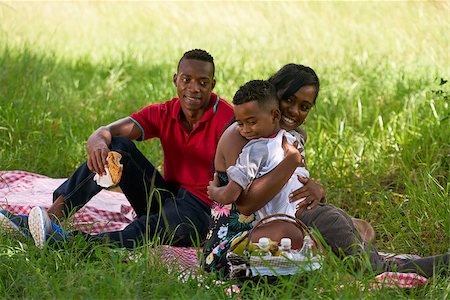 family picnic african american - Happy black couple with son in city park. African american family with young man, woman and child doing picnic, having fun outdoor. Stock Photo - Budget Royalty-Free & Subscription, Code: 400-08816126