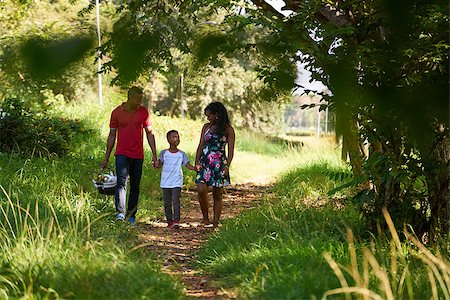 family picnic african american - Happy black couple with son walking in city park. African american family with young man, woman and child doing picnic, having fun outdoor. Stock Photo - Budget Royalty-Free & Subscription, Code: 400-08816127