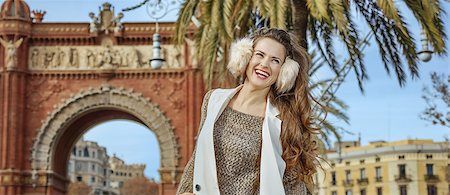 simsearch:400-08415527,k - in Barcelona for a perfect winter. happy young fashion-monger in earmuffs near Arc de Triomf in Barcelona, Spain Stock Photo - Budget Royalty-Free & Subscription, Code: 400-08817848