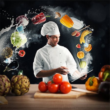 Chef reads a food recipe from the tablet Stock Photo - Budget Royalty-Free & Subscription, Code: 400-08810153