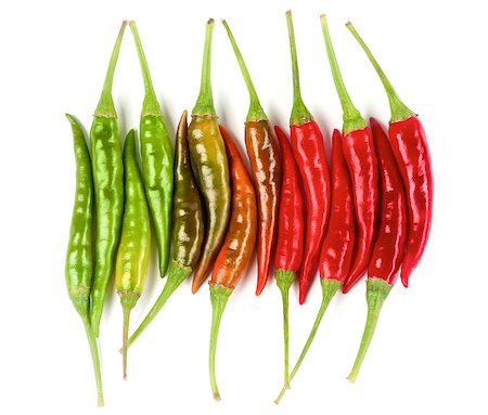 poivre de cayenne - Arrangement of Perfect Shiny Red, Orange and Green Hot Chili Peppers In a Row isolated on White background Photographie de stock - Aubaine LD & Abonnement, Code: 400-08810810