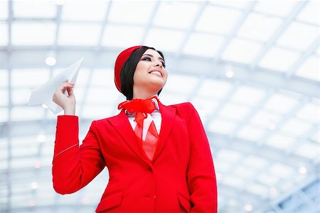 simsearch:400-04429524,k - Young stewardess with a plane Stock Photo - Budget Royalty-Free & Subscription, Code: 400-08811440