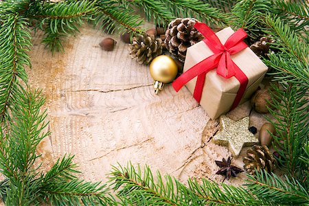 Christmas decoration with gift box and fir branch frame, top view with copy space on wood. Christmas card. Stock Photo - Budget Royalty-Free & Subscription, Code: 400-08812435
