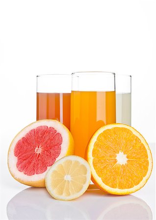 simsearch:400-08814206,k - Glasses of healthy grapefruit and orange and lemon juice on white background Photographie de stock - Aubaine LD & Abonnement, Code: 400-08813143