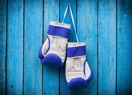 simsearch:400-06876600,k - pair of blue boxing gloves hanging on a nail on a background of blue wooden surface Stock Photo - Budget Royalty-Free & Subscription, Code: 400-08813403