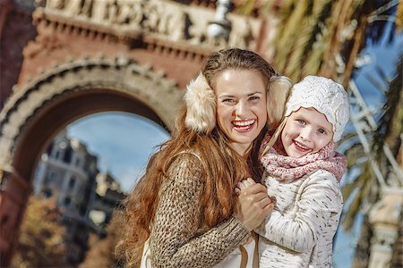 simsearch:400-08864986,k - in Barcelona for a perfect winter. Portrait of smiling trendy mother and child near Arc de Triomf in Barcelona, Spain hugging Stock Photo - Budget Royalty-Free & Subscription, Code: 400-08813576