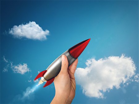 simsearch:400-09112433,k - Businesswoman holding a small rocket. Startup working enterprise concept Stockbilder - Microstock & Abonnement, Bildnummer: 400-08834012