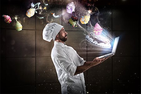 Amazed Chef reads a cooking recipe from his laptop Stock Photo - Budget Royalty-Free & Subscription, Code: 400-08834617