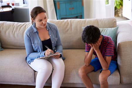 Young Boy With Problems Talking With Counselor At Home Stock Photo - Budget Royalty-Free & Subscription, Code: 400-08837926