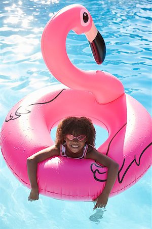 Girl Having Fun With Inflatable In Outdoor Swimming Pool Stock Photo - Budget Royalty-Free & Subscription, Code: 400-08837935