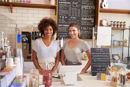 Two women ready to serve behind the counter at a coffee shop Stock Photo - Budget Royalty-Free & Subscription, Code: 400-08837978