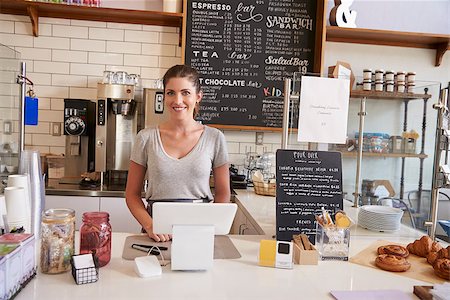 simsearch:400-08838017,k - Woman waiting behind the counter at a coffee shop, close up Photographie de stock - Aubaine LD & Abonnement, Code: 400-08837985