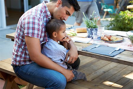 simsearch:400-08838107,k - Father And Son Sitting At Table For Outdoor Meal In Garden Foto de stock - Super Valor sin royalties y Suscripción, Código: 400-08838098