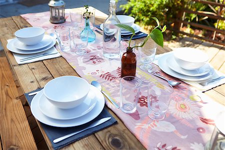 Table Set For Outdoor Meal On Wooden Table In Garden Stock Photo - Budget Royalty-Free & Subscription, Code: 400-08838101