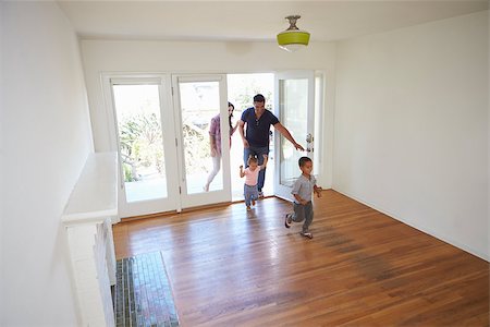 simsearch:400-09122233,k - High Angle View Of  Family Exploring New Home On Moving Day Stock Photo - Budget Royalty-Free & Subscription, Code: 400-08838149