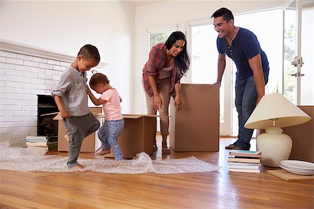 simsearch:400-08938320,k - Family Unpacking Boxes In New Home On Moving Day Stock Photo - Budget Royalty-Free & Subscription, Code: 400-08838154