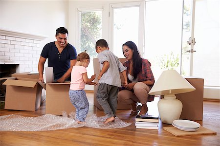 simsearch:400-08938320,k - Family Unpacking Boxes In New Home On Moving Day Stock Photo - Budget Royalty-Free & Subscription, Code: 400-08838155