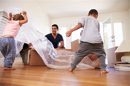 simsearch:400-08938320,k - Family Unpacking Boxes In New Home On Moving Day Stock Photo - Budget Royalty-Free & Subscription, Code: 400-08838156