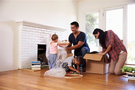 simsearch:400-08938320,k - Family Unpacking Boxes In New Home On Moving Day Stock Photo - Budget Royalty-Free & Subscription, Code: 400-08838159