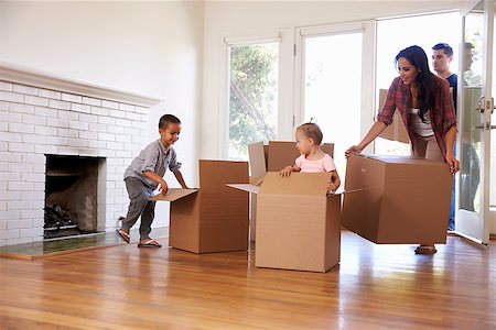 simsearch:400-08938320,k - Family Unpacking Boxes In New Home On Moving Day Stock Photo - Budget Royalty-Free & Subscription, Code: 400-08838152