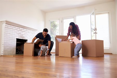 simsearch:400-09122233,k - Family Unpacking Boxes In New Home On Moving Day Stock Photo - Budget Royalty-Free & Subscription, Code: 400-08838153