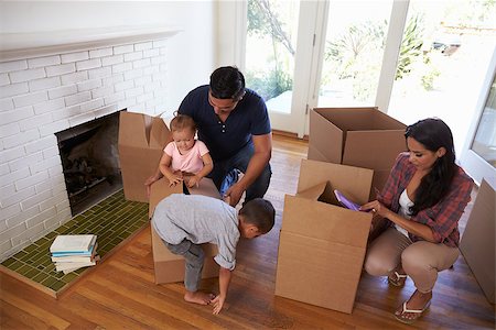 simsearch:400-08938320,k - Family Unpacking Boxes In New Home On Moving Day Stock Photo - Budget Royalty-Free & Subscription, Code: 400-08838166