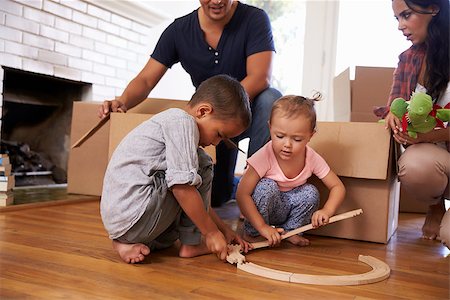 simsearch:400-08938320,k - Family Unpacking Boxes In New Home On Moving Day Stock Photo - Budget Royalty-Free & Subscription, Code: 400-08838161