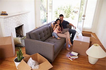 simsearch:400-08938320,k - Family Take A Break On Sofa Using Laptop On Moving Day Stock Photo - Budget Royalty-Free & Subscription, Code: 400-08838170